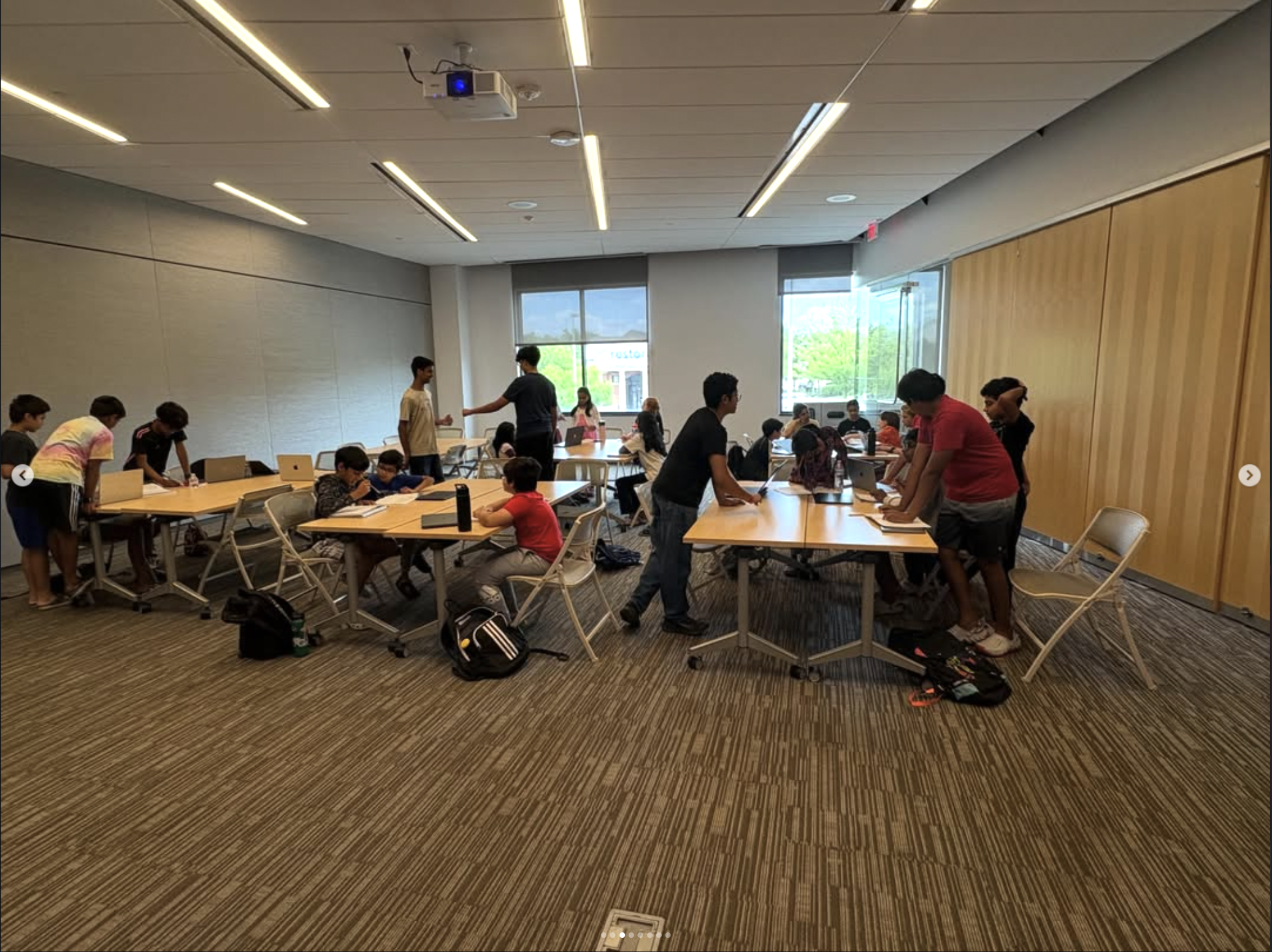 Students working at tables during a workshop