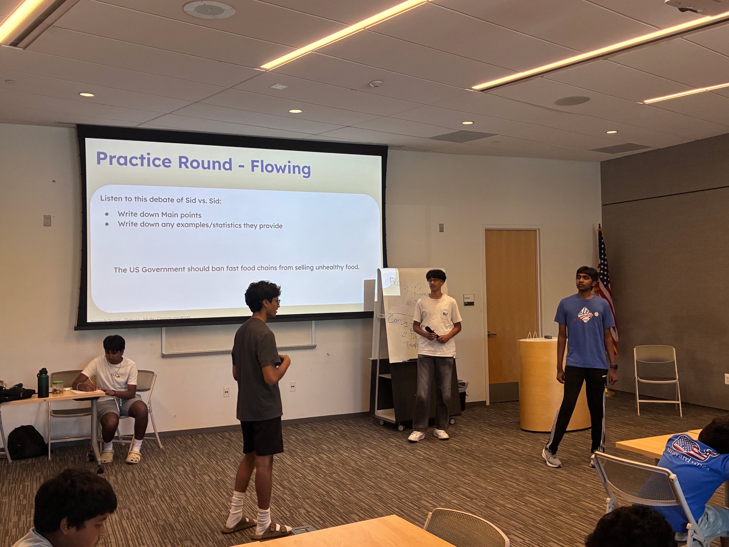 A student volunteer leading a debate activity
